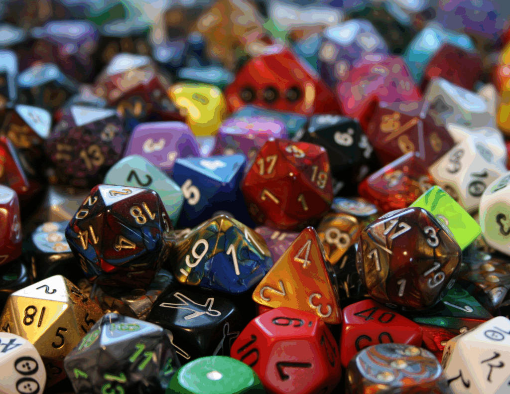 A vibrant pile of colorful polyhedral Dungeons & Dragons dice, representing neurodivergent-affirming therapy as a personal quest